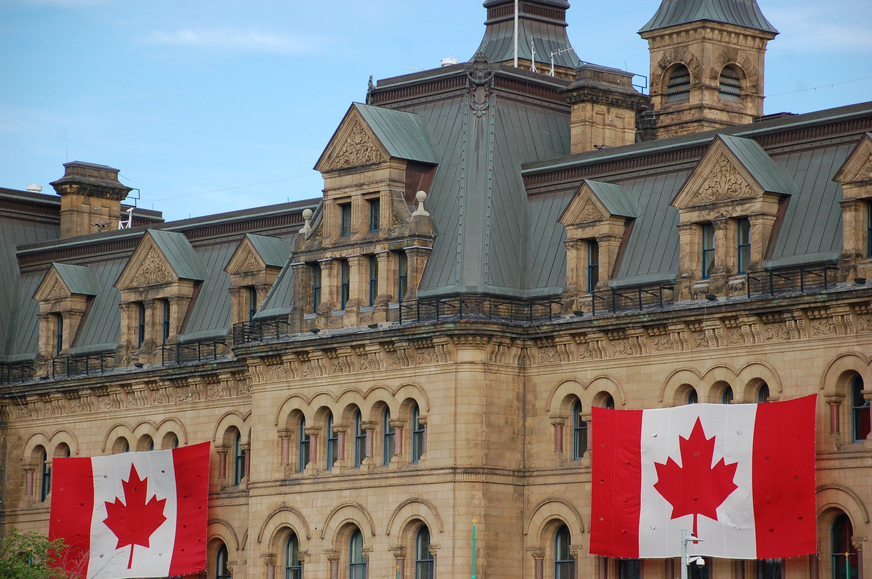 This is a picture of the canadian parliament with the canadian flag